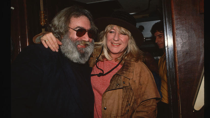 Jerry Garcia, singer of The Grateful Dead, and Christine McVie of Fleetwood Mac hugging. (Photo by LGI Stock/Corbis/VCG via Getty Images)